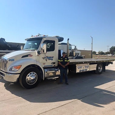 Driver beside tow truck sq